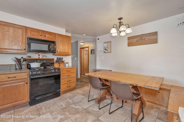 1186 Washington St, Craig, CO 81625 - kitchen featuring black appliances, a chandelier, light countertops, hanging light fixtures, and brown cabinets