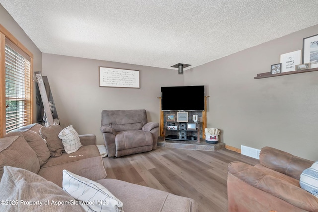 1186 Washington St, Craig, CO 81625 - living area featuring a textured ceiling and wood finished floors