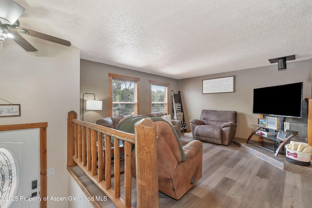 1186 Washington St, Craig, CO 81625 - living area with a textured ceiling, wood finished floors, and a ceiling fan