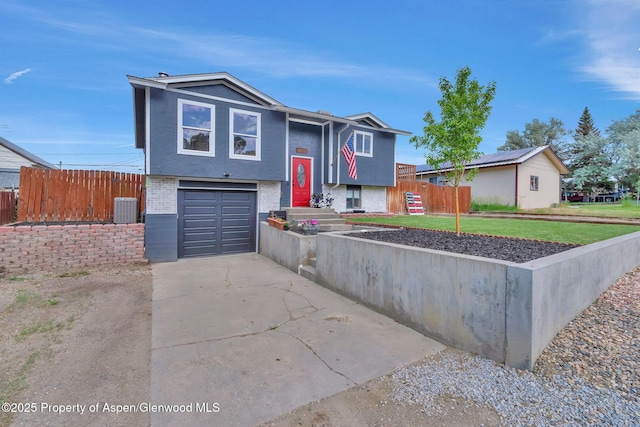 1186 Washington St, Craig, CO 81625 - view of front of property featuring brick siding, a garage, driveway, and stucco siding