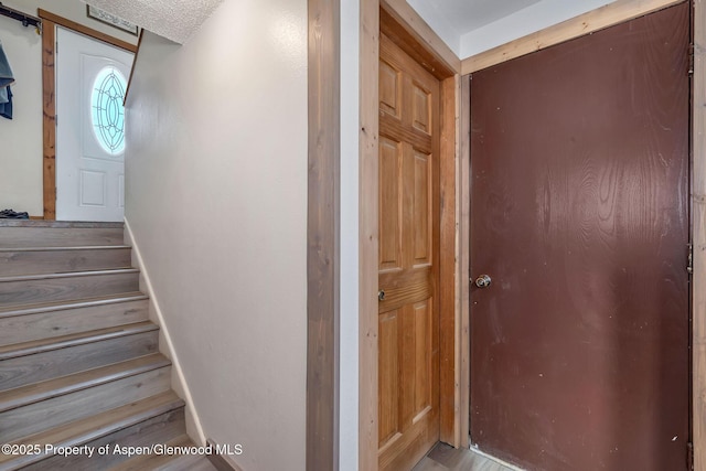 1186 Washington St, Craig, CO 81625 - staircase featuring wood finished floors and a barn door