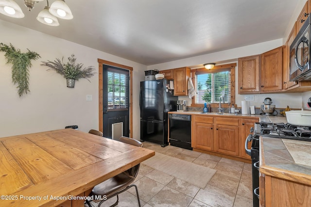 1186 Washington St, Craig, CO 81625 - kitchen featuring black appliances, tile counters, plenty of natural light, and brown cabinetry