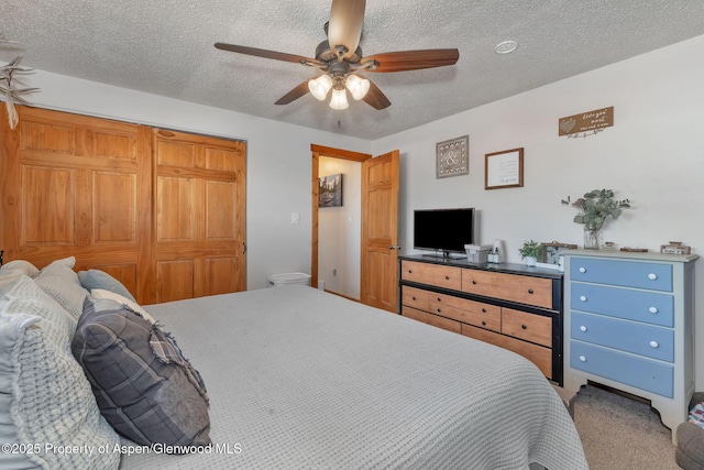 1186 Washington St, Craig, CO 81625 - bedroom featuring a textured ceiling, ceiling fan, a closet, and carpet flooring