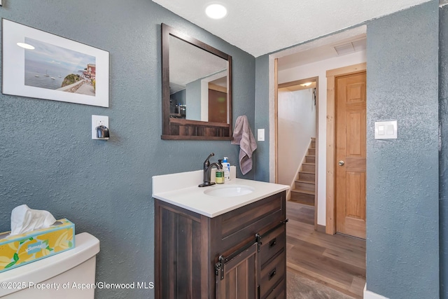 1186 Washington St, Craig, CO 81625 - bathroom with a textured wall, vanity, and wood finished floors