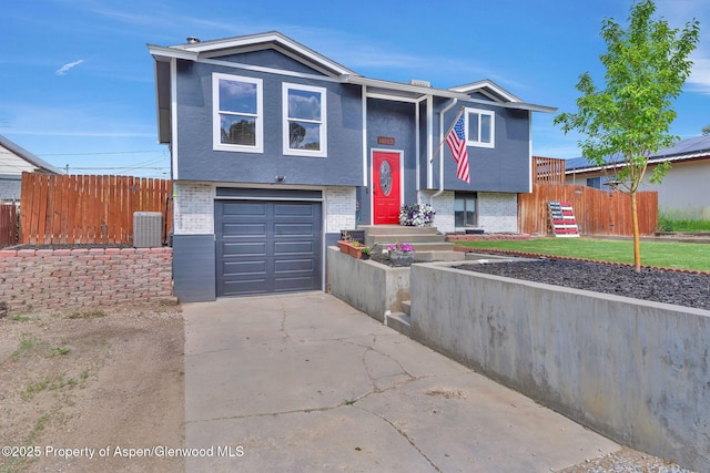 1186 Washington St, Craig, CO 81625 - raised ranch with brick siding, an attached garage, driveway, and stucco siding