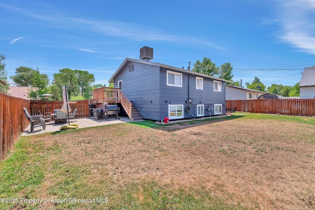 1186 Washington St, Craig, CO 81625 - back of property with a fenced backyard, a patio area, stairway, and a wooden deck