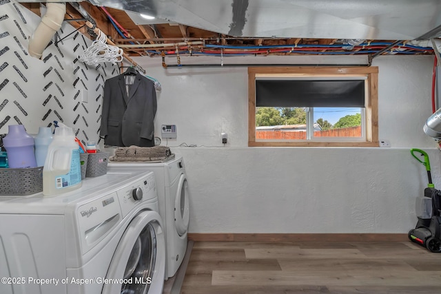 1186 Washington St, Craig, CO 81625 - laundry area with washing machine and dryer and wood finished floors