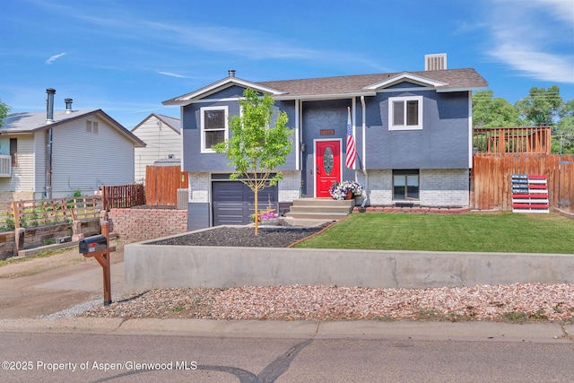 1186 Washington St, Craig, CO 81625 - split foyer home featuring an attached garage, brick siding, stucco siding, and driveway