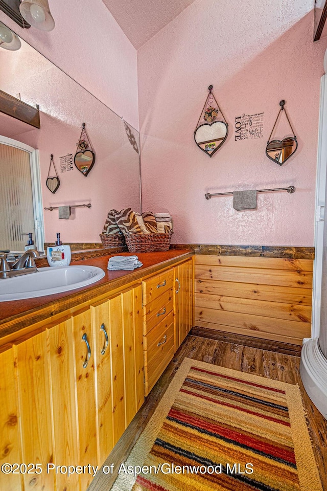 37 Pronghorn Rd, Craig, CO 81625 - full bath with wood finished floors, double vanity, and a textured ceiling