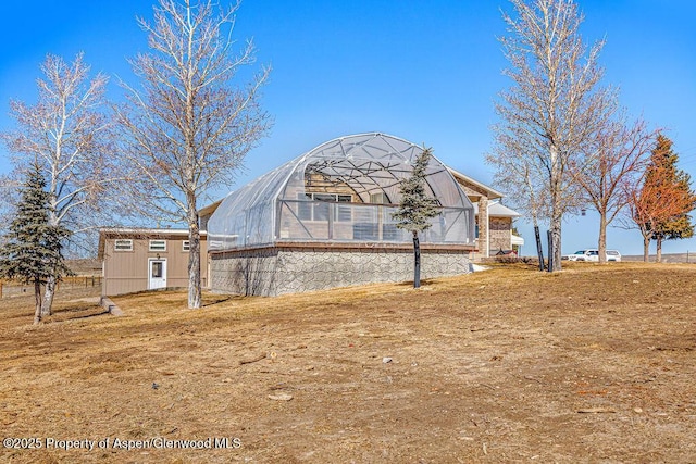 37 Pronghorn Rd, Craig, CO 81625 - rear view of property with a greenhouse and an outdoor structure