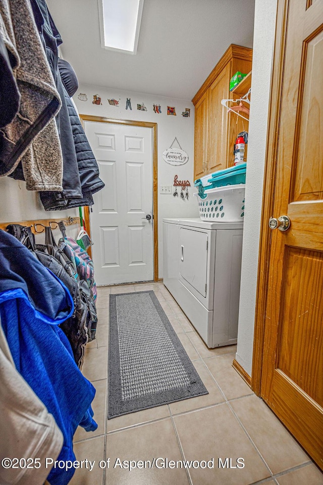 37 Pronghorn Rd, Craig, CO 81625 - laundry area featuring independent washer and dryer, light tile patterned flooring, and cabinet space