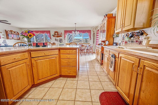 37 Pronghorn Rd, Craig, CO 81625 - kitchen featuring light countertops, light tile patterned floors, a ceiling fan, and brown cabinets