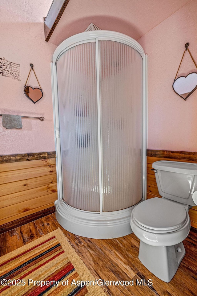 37 Pronghorn Rd, Craig, CO 81625 - full bathroom featuring a stall shower, wood finished floors, and a wainscoted wall