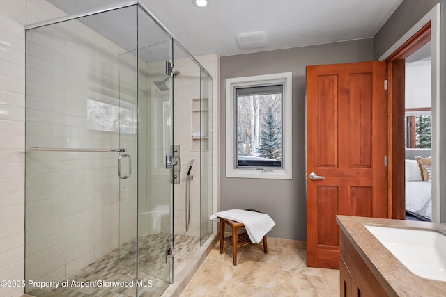 bathroom with vanity and a shower with door