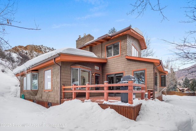 snow covered property with a mountain view