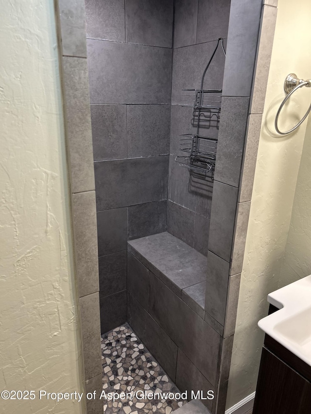 bathroom with tiled shower