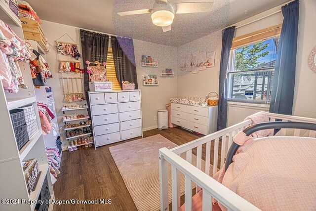 bedroom featuring ceiling fan and dark wood-type flooring