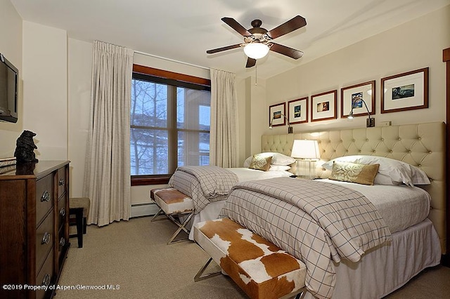 carpeted bedroom with ceiling fan, a baseboard radiator, and multiple windows