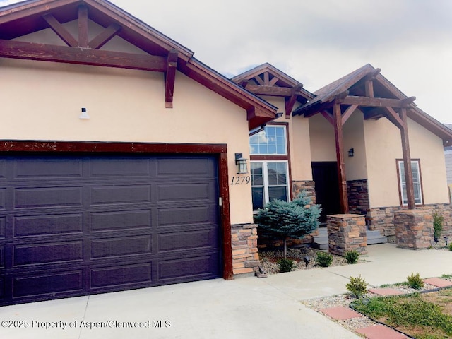 1279 E 17th St, Rifle, CO 81650 - view of front facade featuring stone siding, stucco siding, and concrete driveway