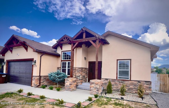1279 E 17th St, Rifle, CO 81650 - view of front of house with stone siding, stucco siding, an attached garage, and concrete driveway