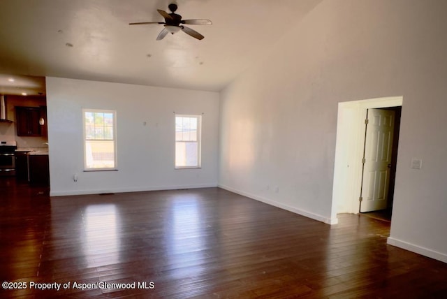 1279 E 17th St, Rifle, CO 81650 - unfurnished living room with a ceiling fan, dark wood-type flooring, and lofted ceiling