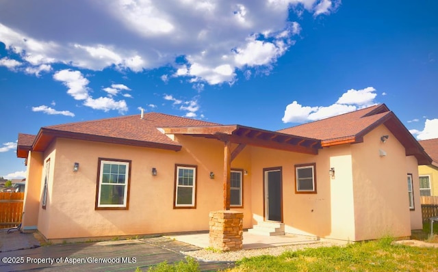 1279 E 17th St, Rifle, CO 81650 - back of house with stucco siding, entry steps, a patio area, and a shingled roof