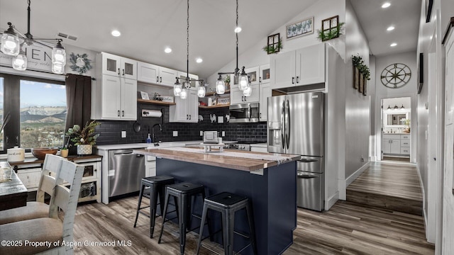 450 E 10th St, Rifle, CO 81650 - kitchen with visible vents, wooden counters, stainless steel appliances, a kitchen island, and open shelves