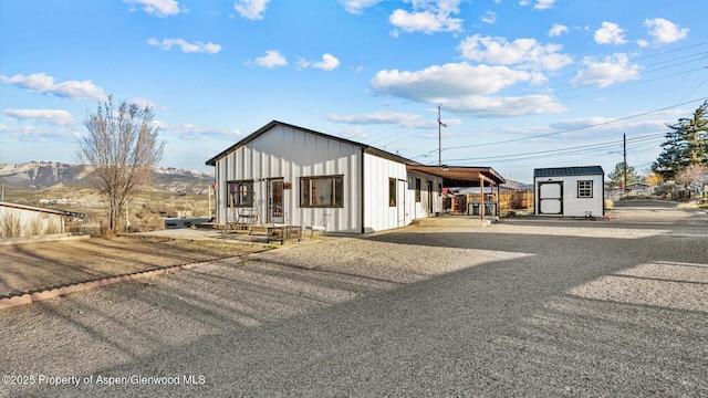 450 E 10th St, Rifle, CO 81650 - view of front of house with an outbuilding, a storage shed, and board and batten siding