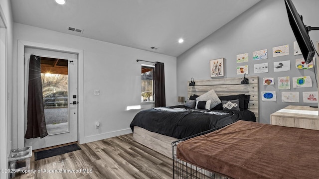 450 E 10th St, Rifle, CO 81650 - bedroom with wood finished floors, baseboards, vaulted ceiling, and visible vents