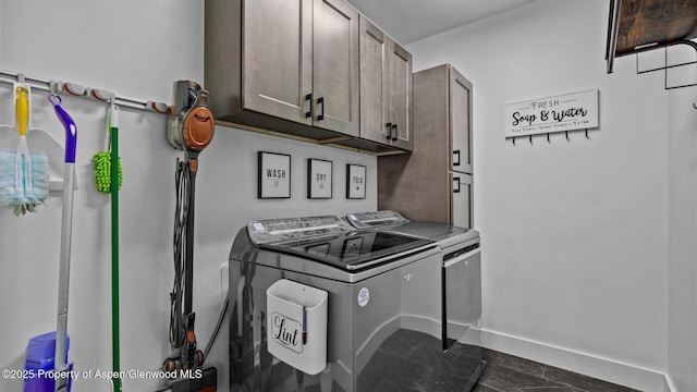 450 E 10th St, Rifle, CO 81650 - clothes washing area with baseboards, washing machine and clothes dryer, and cabinet space