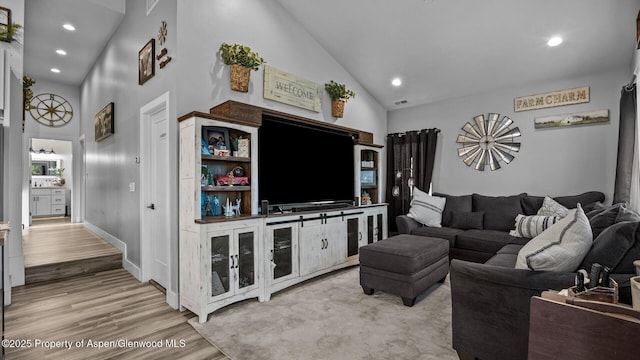 450 E 10th St, Rifle, CO 81650 - living room featuring recessed lighting, high vaulted ceiling, and wood finished floors