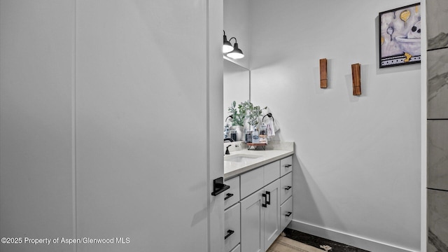 450 E 10th St, Rifle, CO 81650 - bathroom with baseboards and vanity