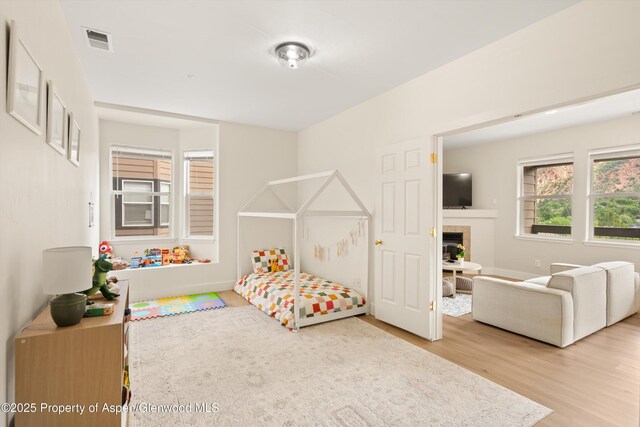 2701 Midland Ave Unit 725, Glenwood Springs, CO 81601 - bedroom featuring wood finished floors and a fireplace