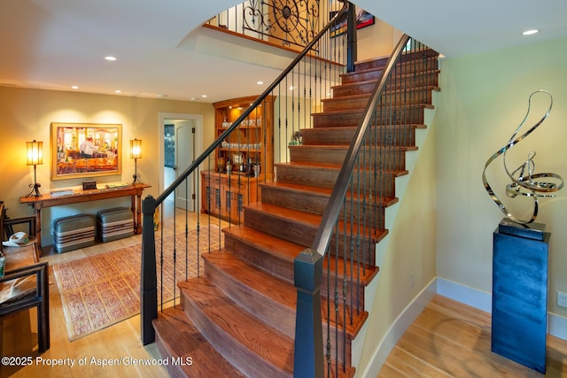 staircase with wood-type flooring