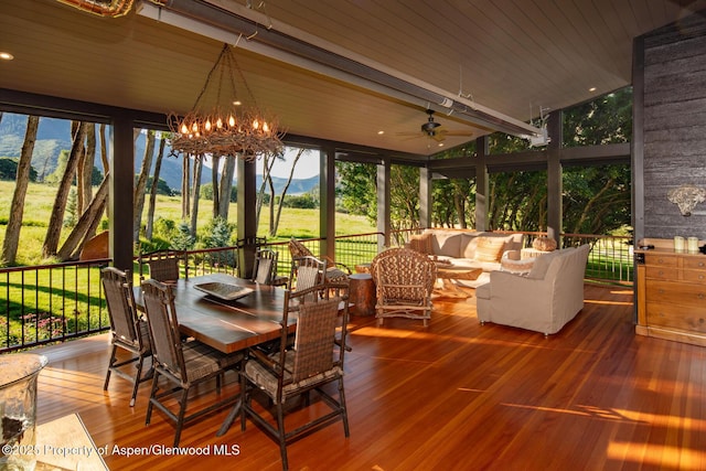 sunroom with a mountain view, wooden ceiling, and a chandelier