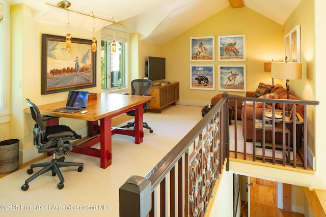 carpeted office featuring lofted ceiling