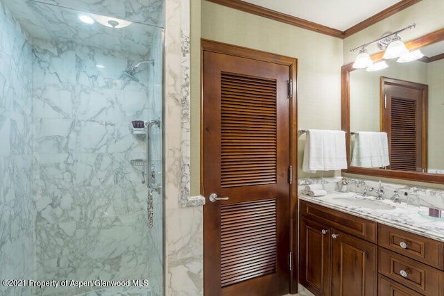 bathroom featuring vanity, a shower with door, and ornamental molding