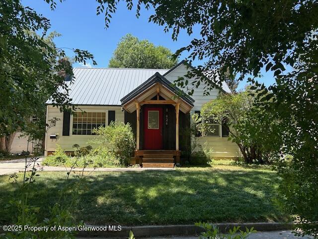 624 Barclay St, Craig, CO 81625 - view of front of house with a front lawn and a metal roof