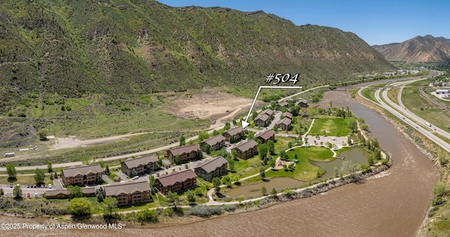 aerial view of property's location with a water and mountain view