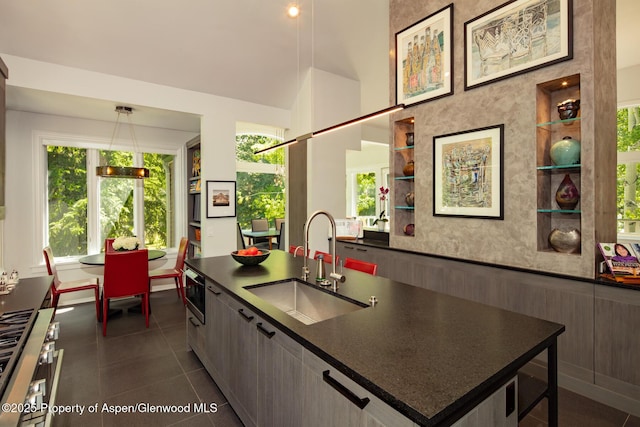 205 N 6th St, Aspen, CO 81611 - kitchen with dark countertops, dark tile patterned floors, built in shelves, open shelves, and pendant lighting