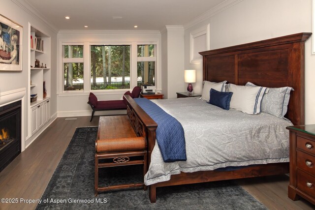 205 N 6th St, Aspen, CO 81611 - bedroom featuring dark wood-type flooring, ornamental molding, recessed lighting, and a warm lit fireplace