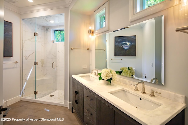 205 N 6th St, Aspen, CO 81611 - full bath with double vanity, a marble finish shower, ornamental molding, wood finished floors, and recessed lighting