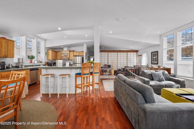 living area featuring recessed lighting, dark wood-type flooring, and vaulted ceiling