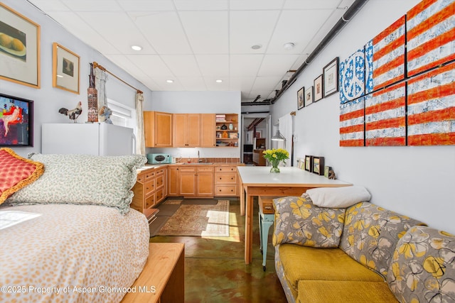 kitchen with open shelves, a drop ceiling, a sink, light countertops, and white microwave