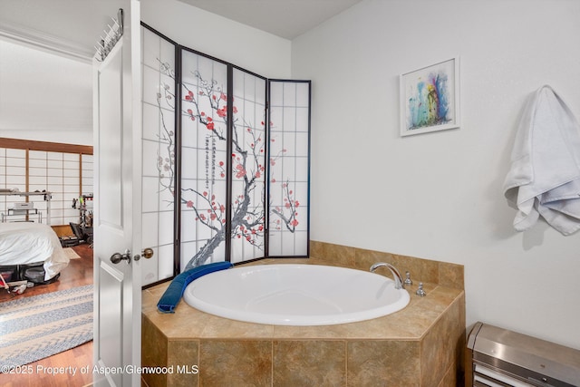 ensuite bathroom with a bath, connected bathroom, and wood finished floors