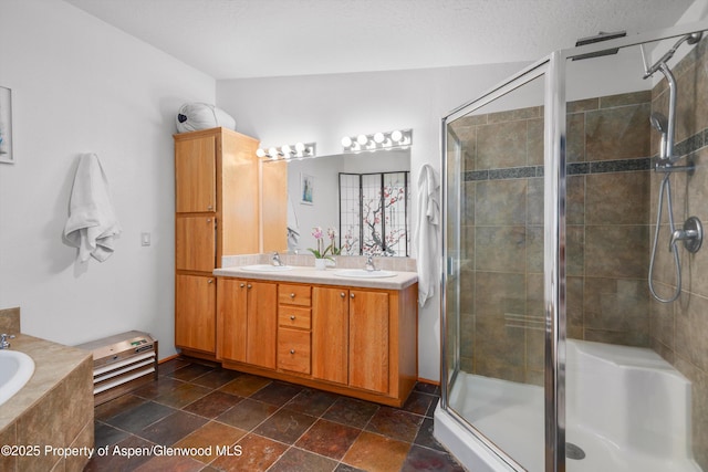 full bath featuring a shower stall, a bath, double vanity, and a sink