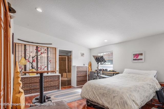 bedroom with wood finished floors, recessed lighting, a textured ceiling, and vaulted ceiling