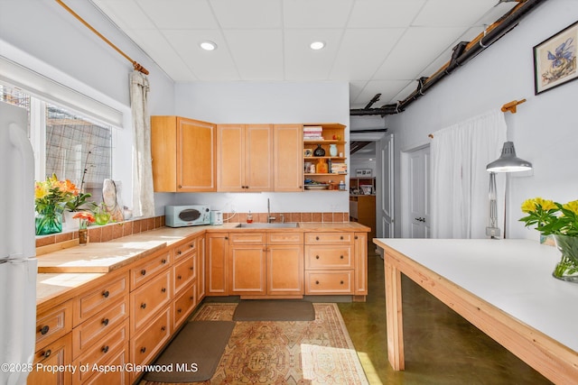 kitchen with white appliances, open shelves, recessed lighting, a sink, and a paneled ceiling