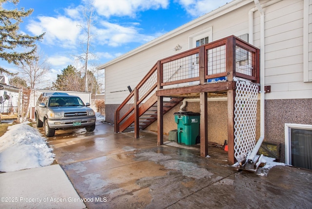 view of side of property featuring stairway