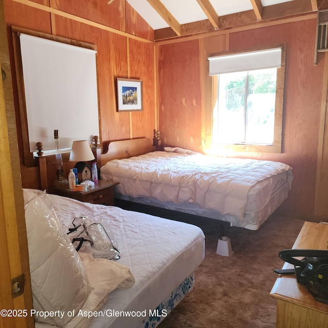 bedroom with vaulted ceiling with beams, carpet, and wooden walls